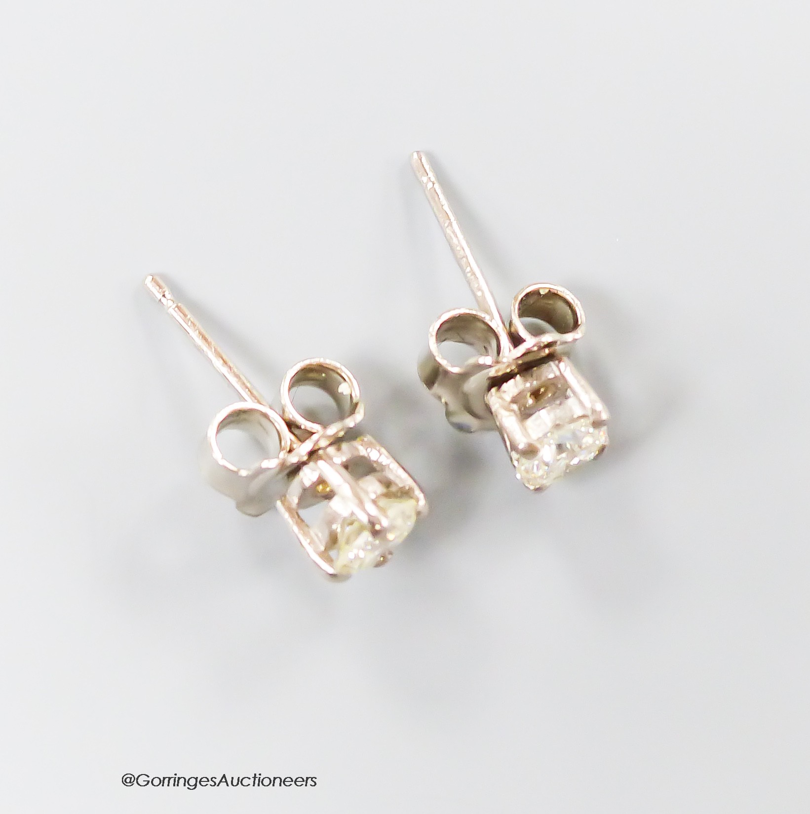 A modern pair of 750 white metal and solitaire diamond ear studs, each stone weighing approximately 0.23ct, gross weight 1.3 grams.